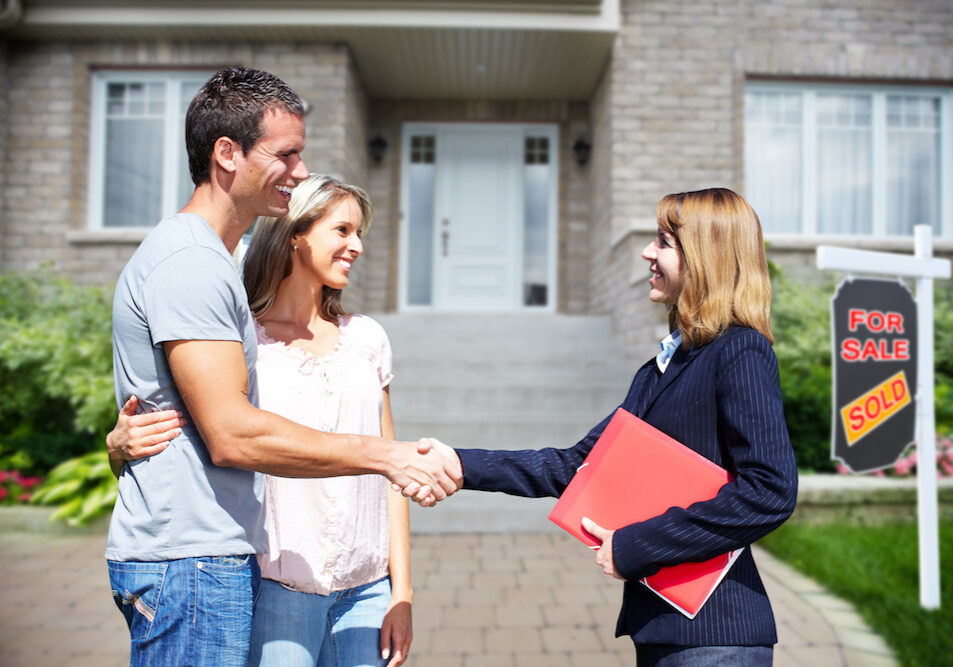 Happy Family near new home. Residential construction background.