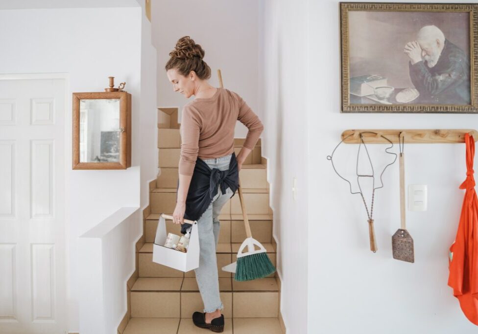 woman holding cleaning materials