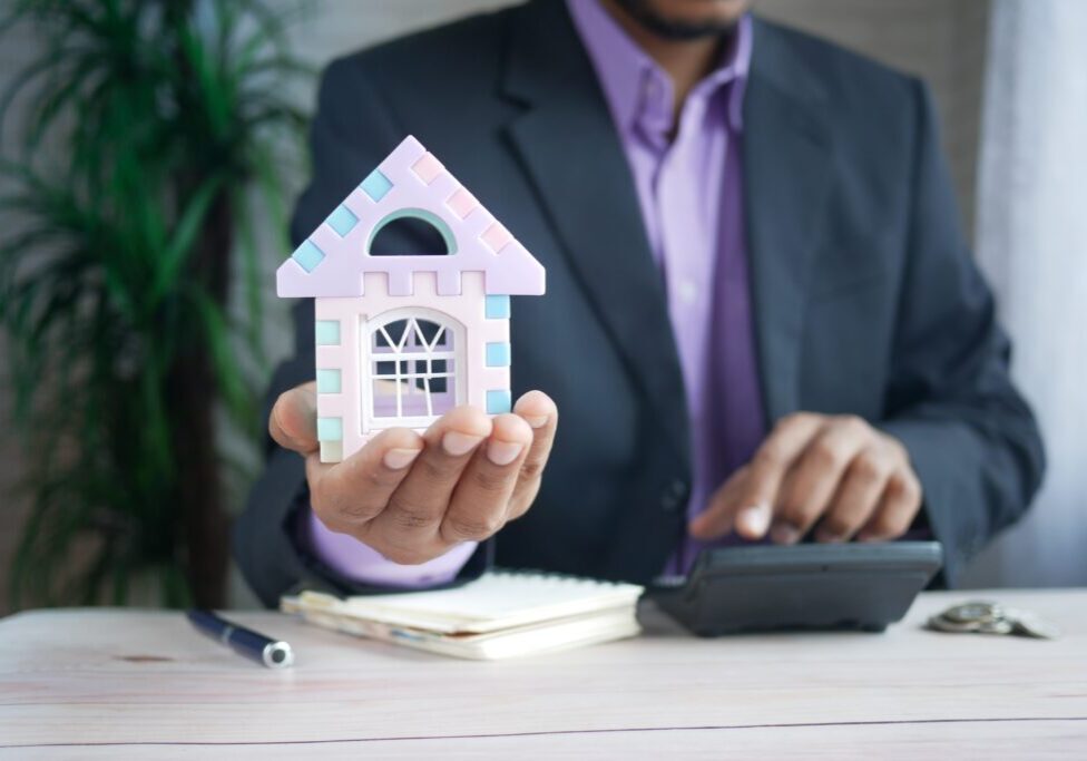 hand holding a model house